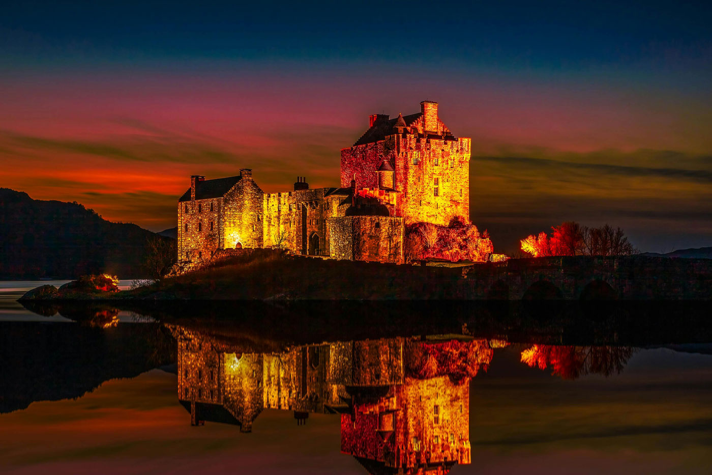 Lit castle at sunset symbolising privacy, security and household staff recruitment for HNW families