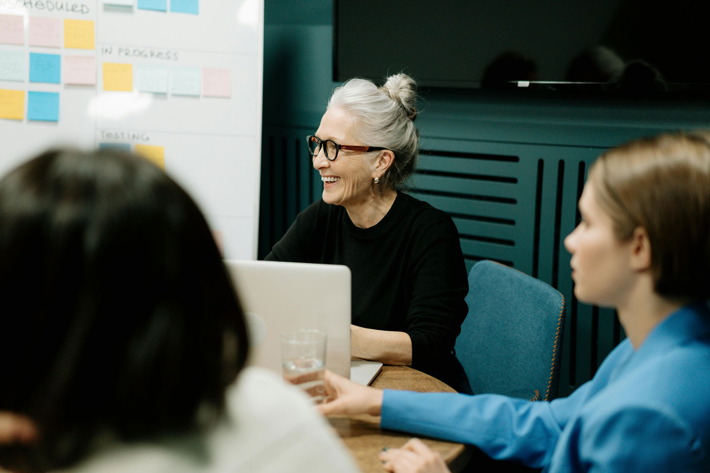 Senior consultant smiling during a meeting, representing expertise in household staff recruitment